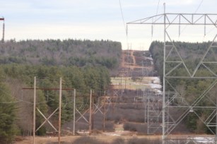 High voltage power lines cross a hillside