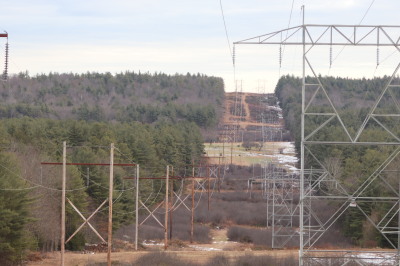 High voltage power lines cross a hillside