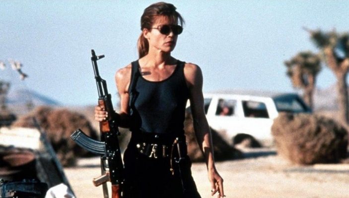 Linda Hamilton holding gun and ready to fight in Terminator 2.