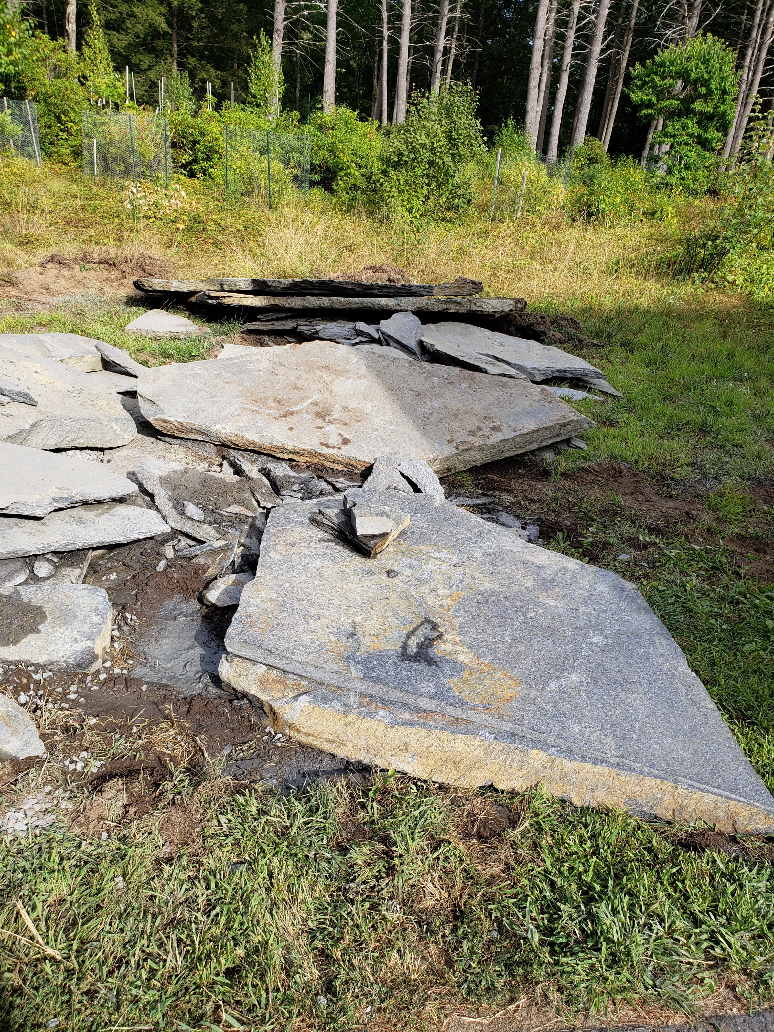Photo shows two large slabs of stone and other small pieces.