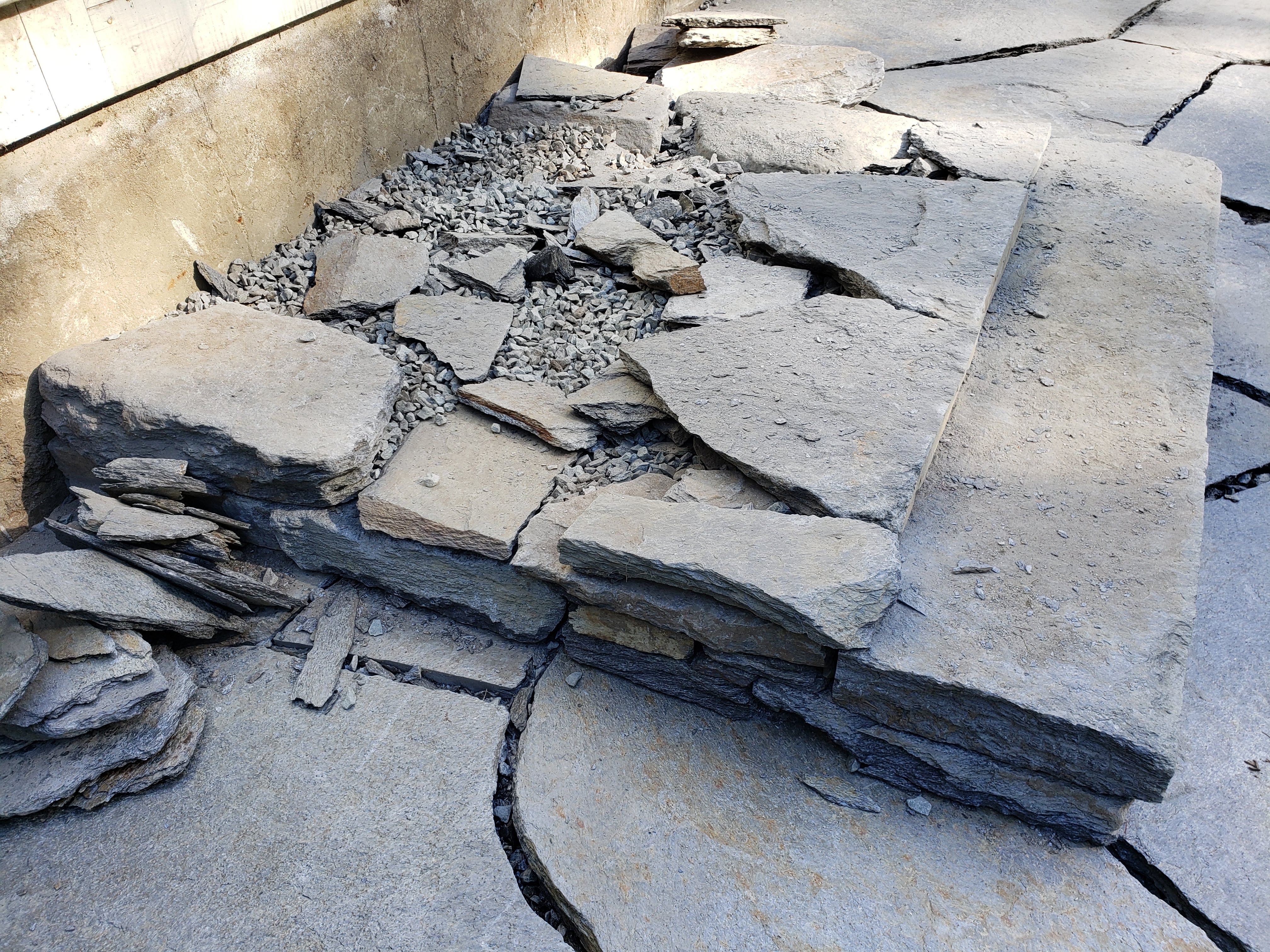 Photo shows stone stairs being built with small pieces of rock and gravel