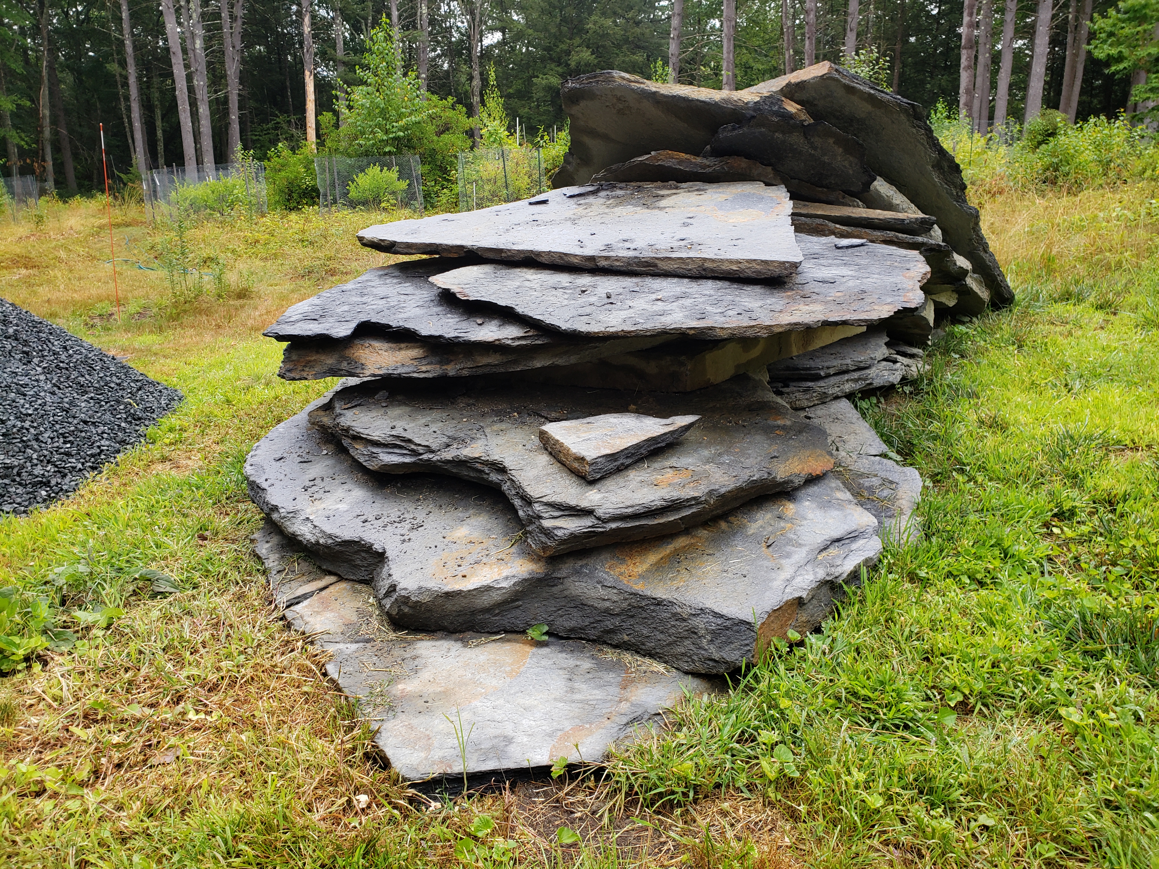 Photo shows a large pile of flat gray stones called Goshen stone