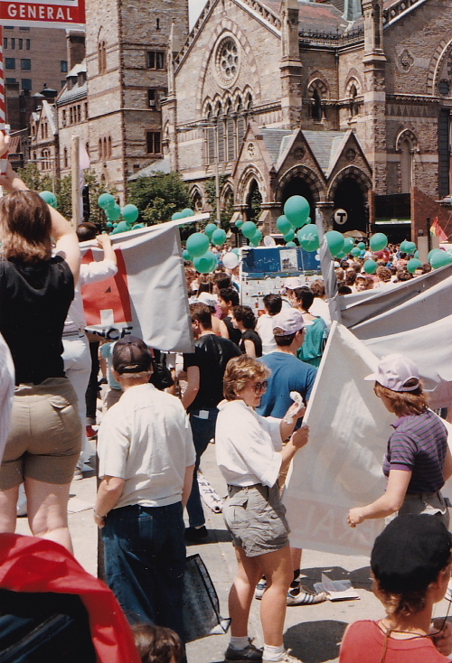 Photo from 1986 shows a group of people with balloons and banners by Boston's Arlington Street Church at Boston's Pride Parade