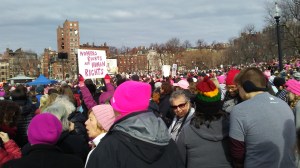 Photo shows the Boston Women's March Jan. 21, 2017, with people wearing pink "pussy" hats and a sign "Women's Rights are Human Rights"